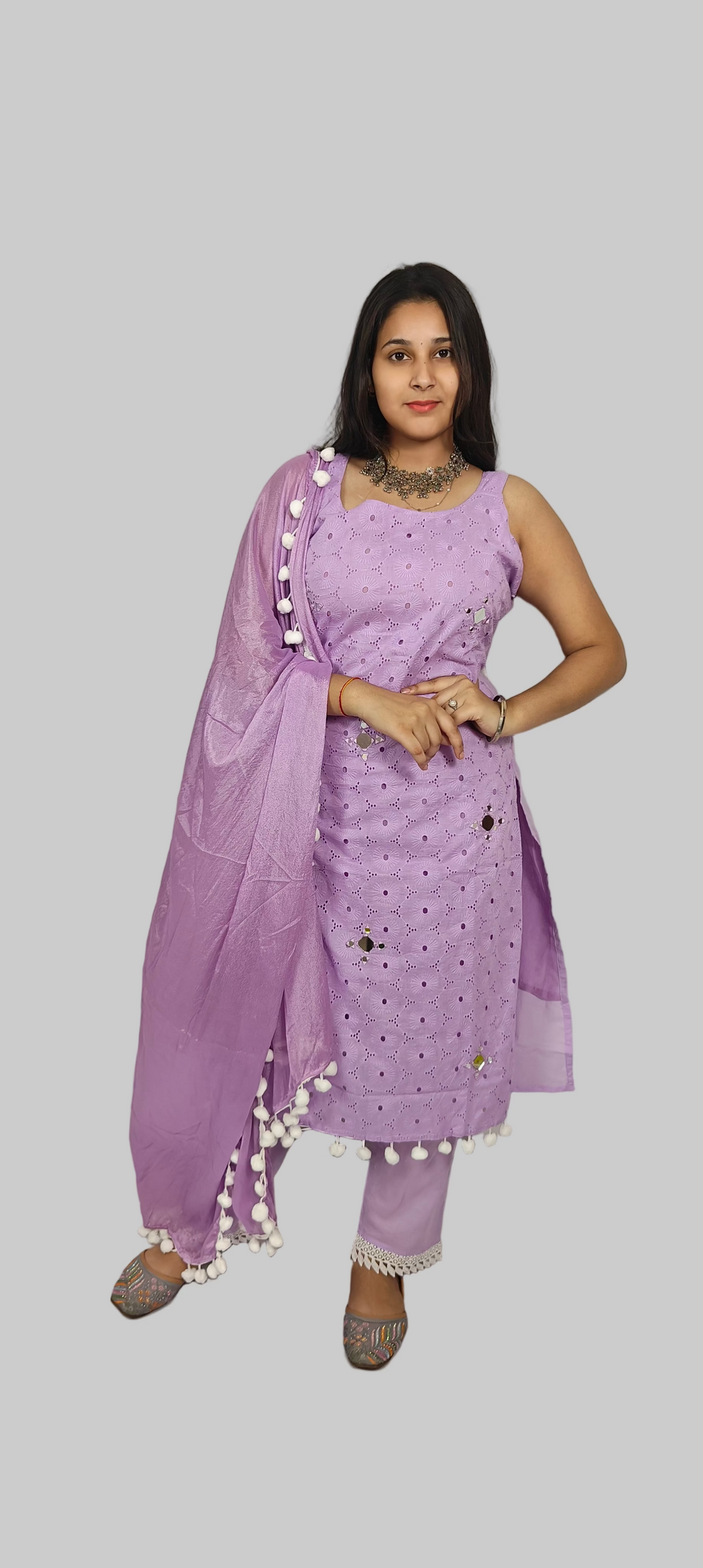 Woman wearing a purple traditional outfit with a plain background