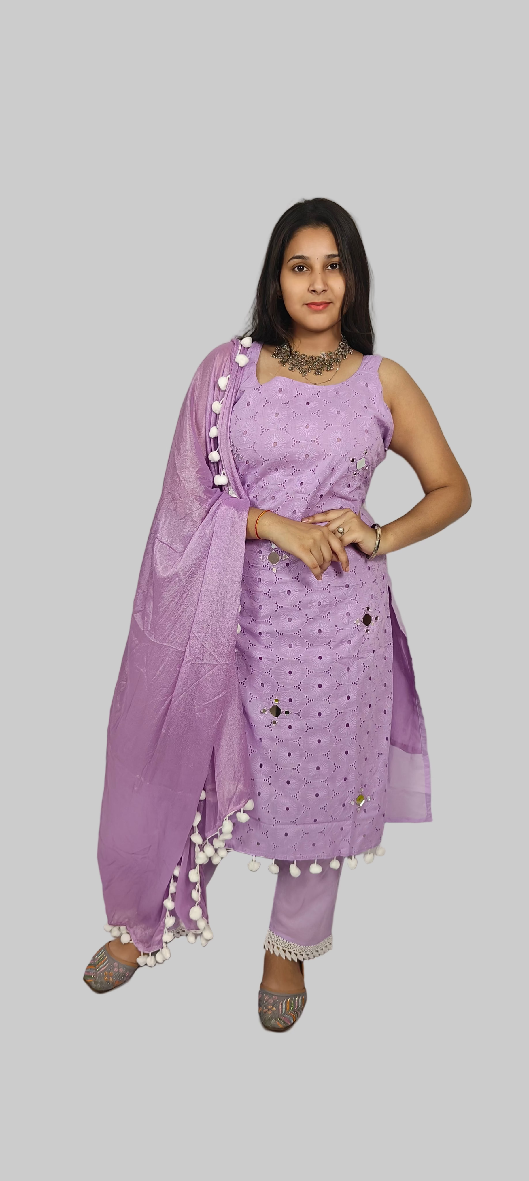 Woman wearing a purple traditional outfit with a plain background