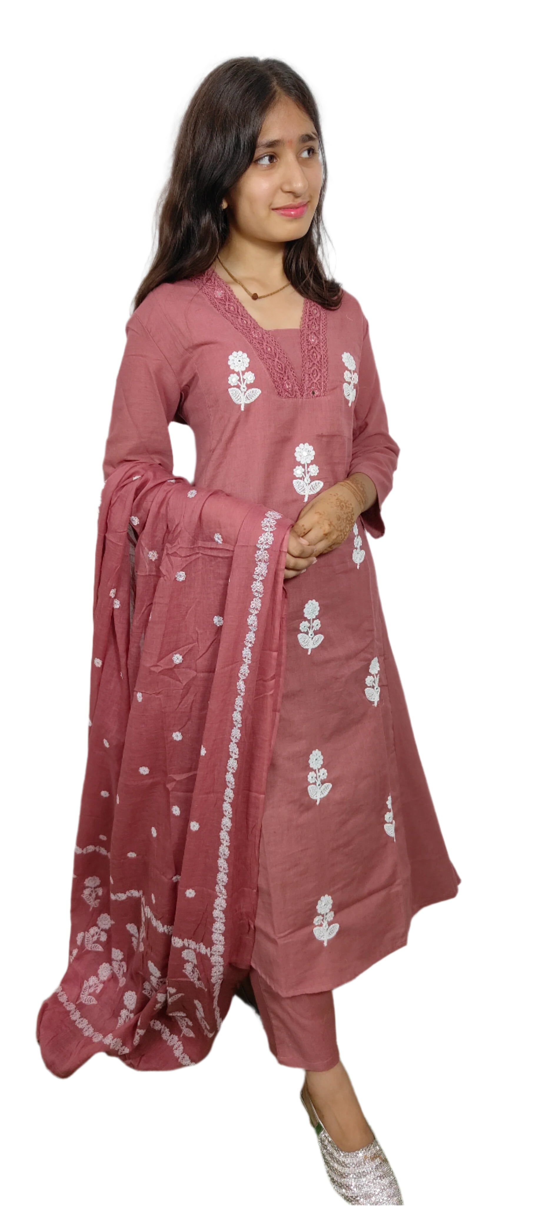 Woman wearing a pink traditional outfit with white floral patterns on a white background