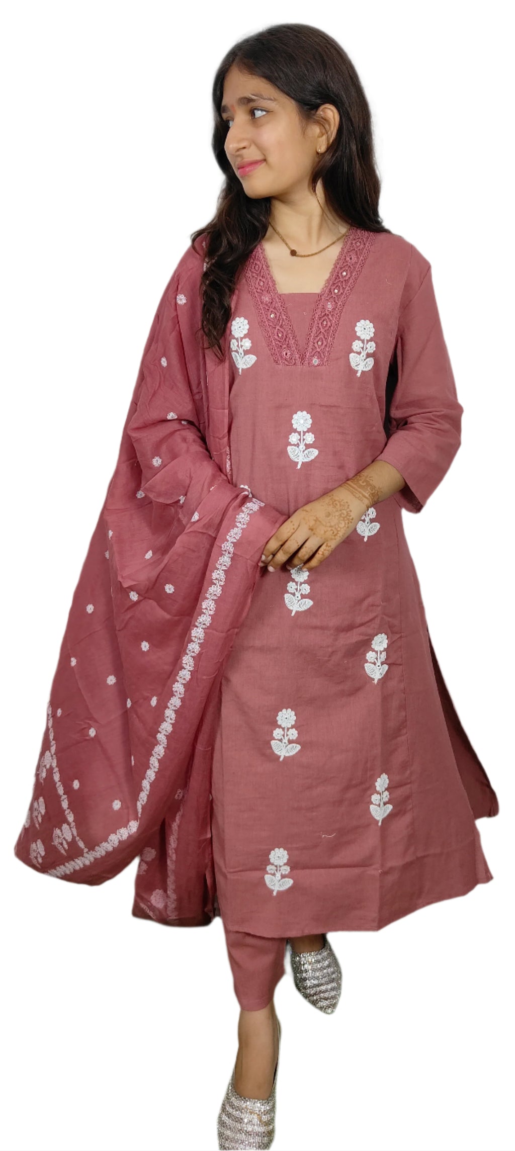 Woman wearing a pink traditional outfit with white floral patterns on a white background