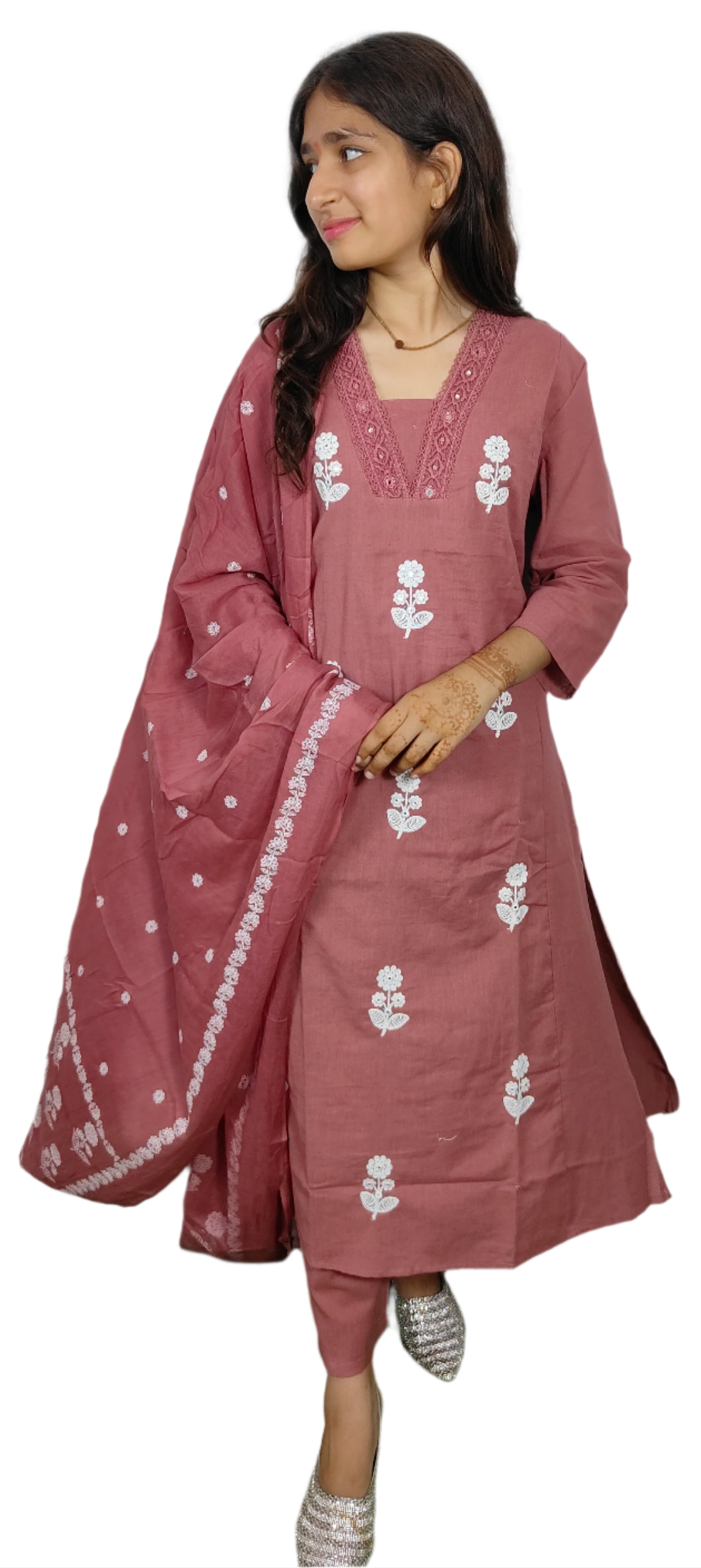 Woman wearing a pink traditional outfit with white floral patterns on a white background